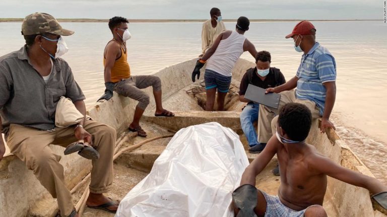 Un corpo è avvolto in teli di plastica dopo essere stato recuperato dalla riva del fiume da Wad El Hilou, in Sudan.